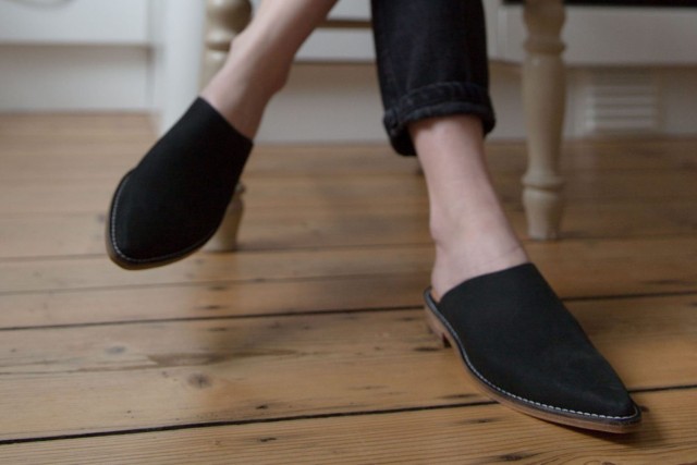 woman wearing black slip on shoes